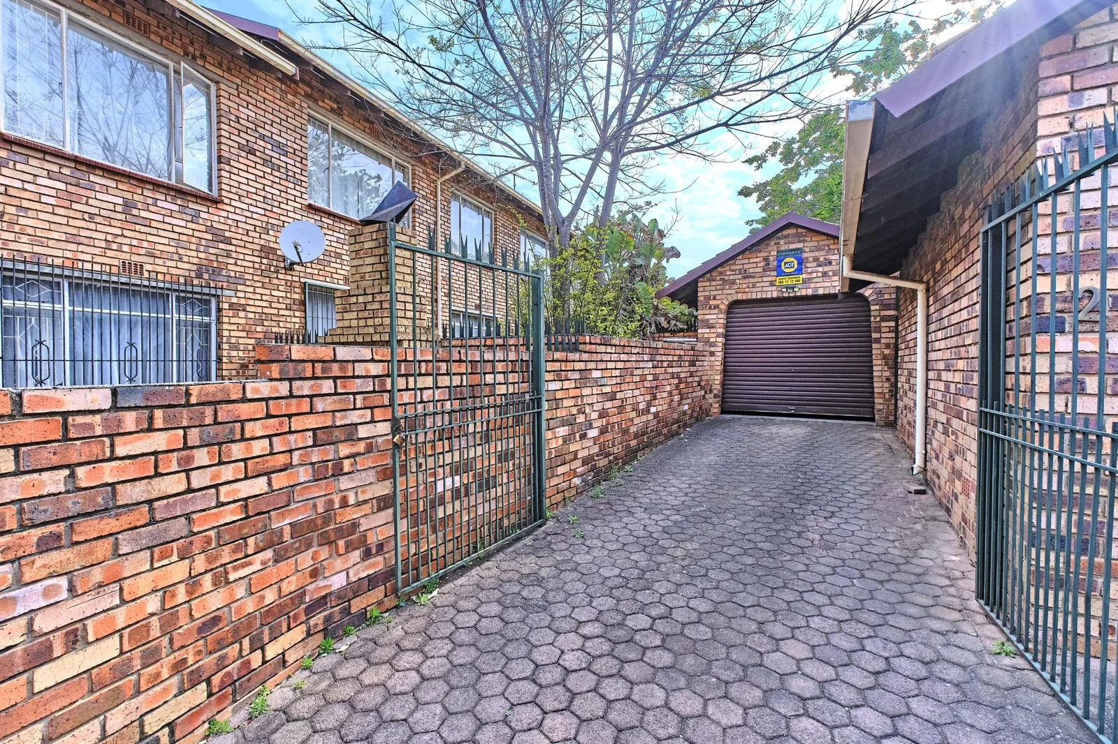 Double-story Townhouse with living spaces below, bedrooms upstairs, and a private garden.