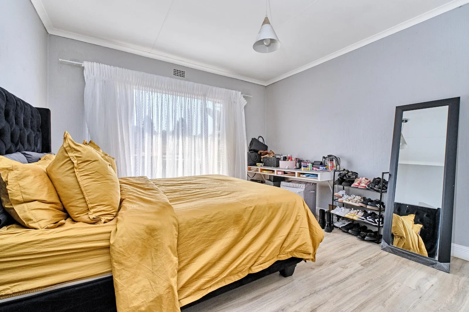 Double-story Townhouse with living spaces below, bedrooms upstairs, and a private garden.