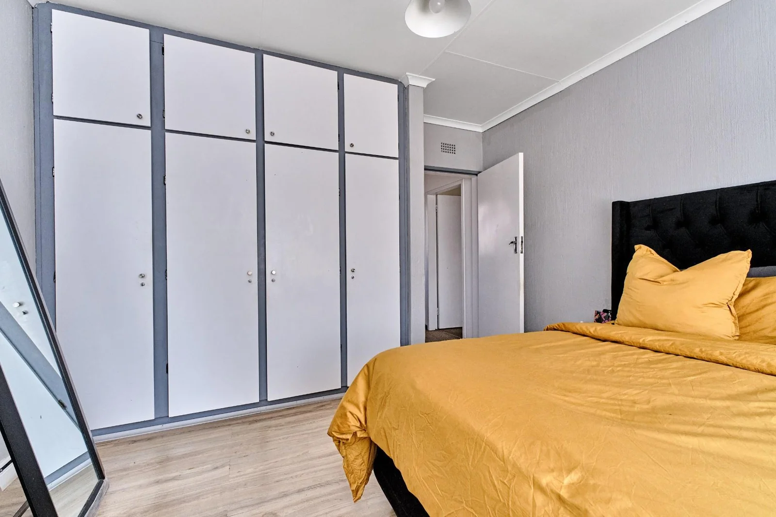 Double-story Townhouse with living spaces below, bedrooms upstairs, and a private garden.