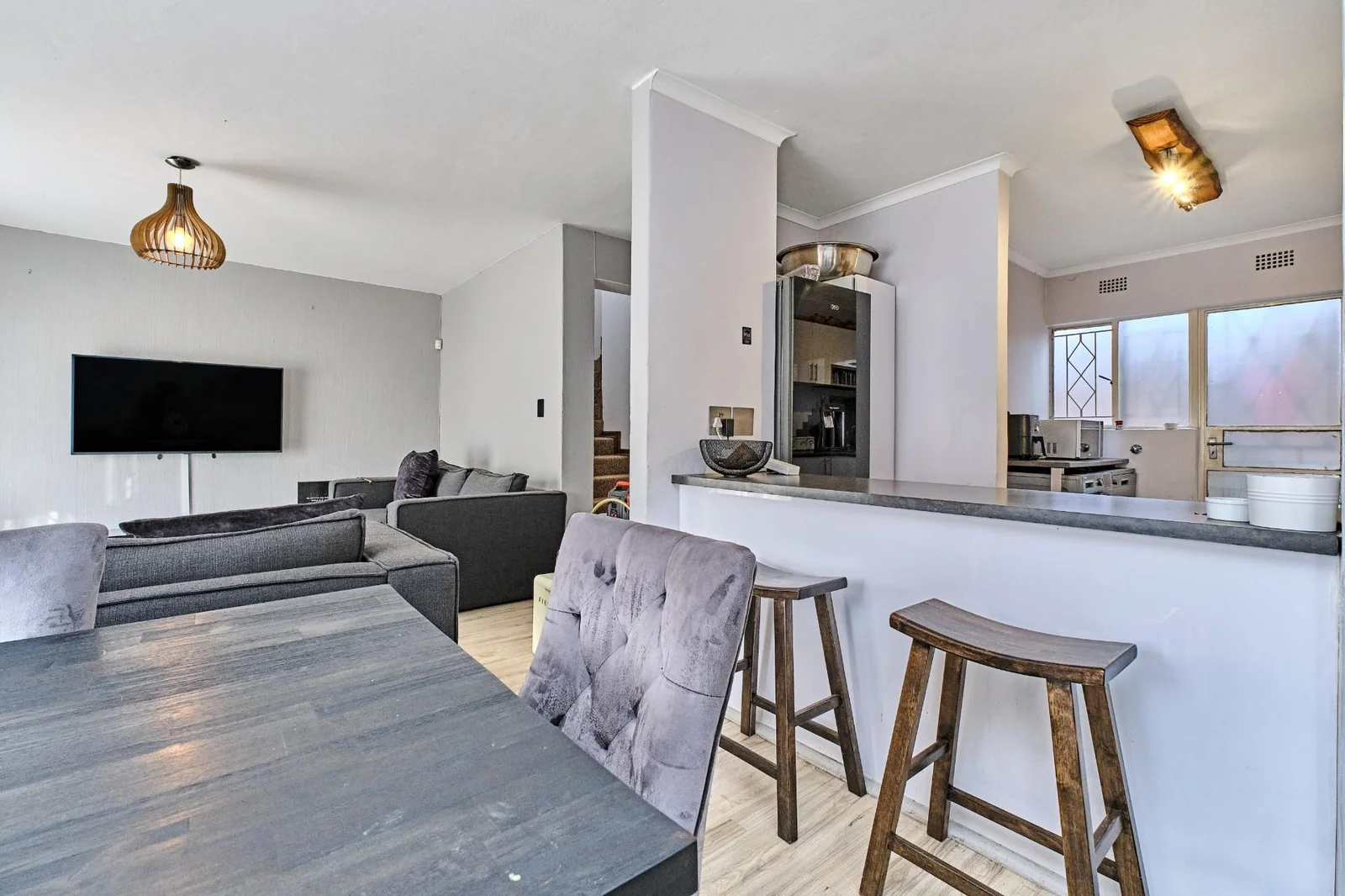 Double-story Townhouse with living spaces below, bedrooms upstairs, and a private garden.