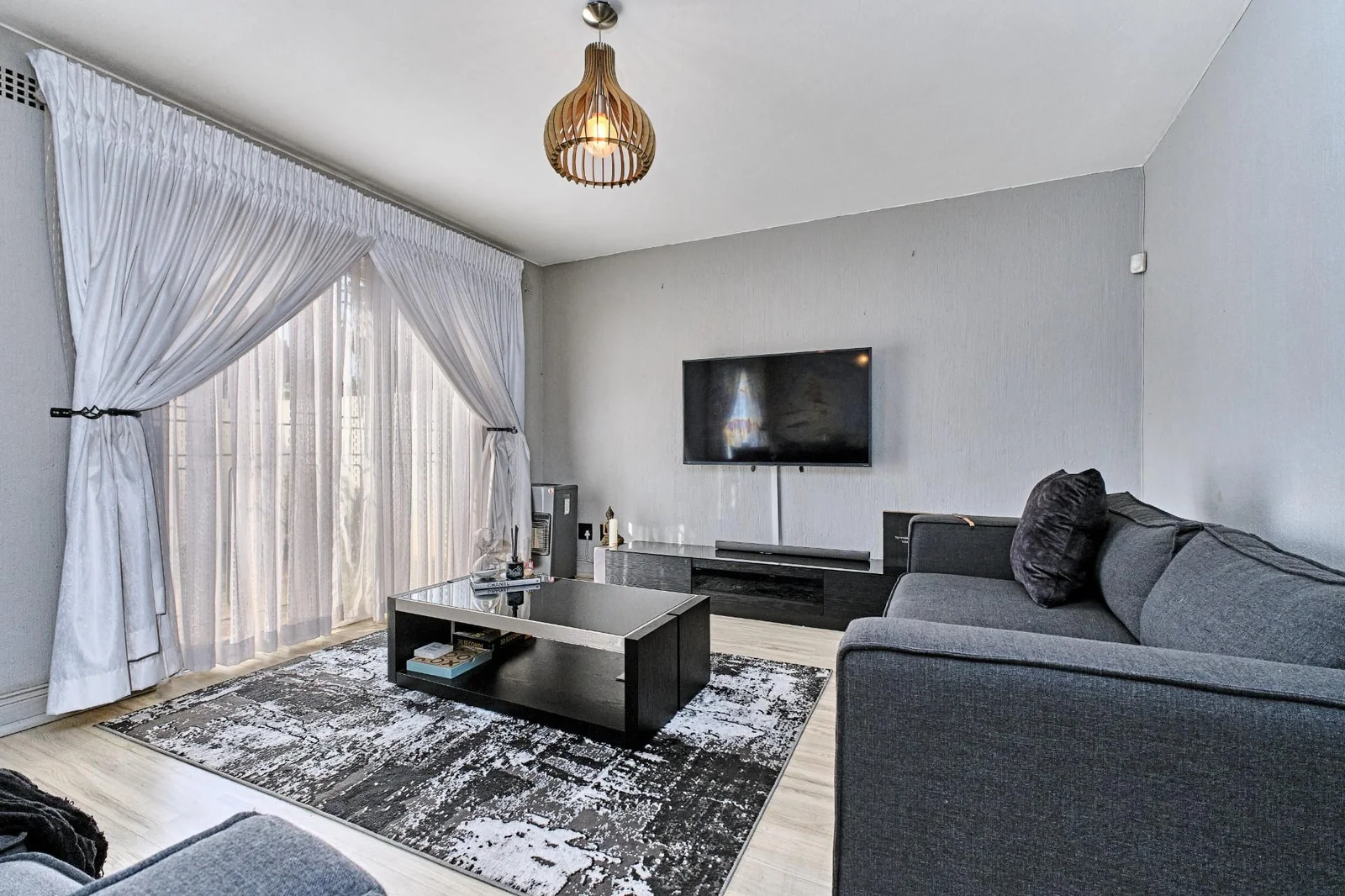 Double-story Townhouse with living spaces below, bedrooms upstairs, and a private garden.