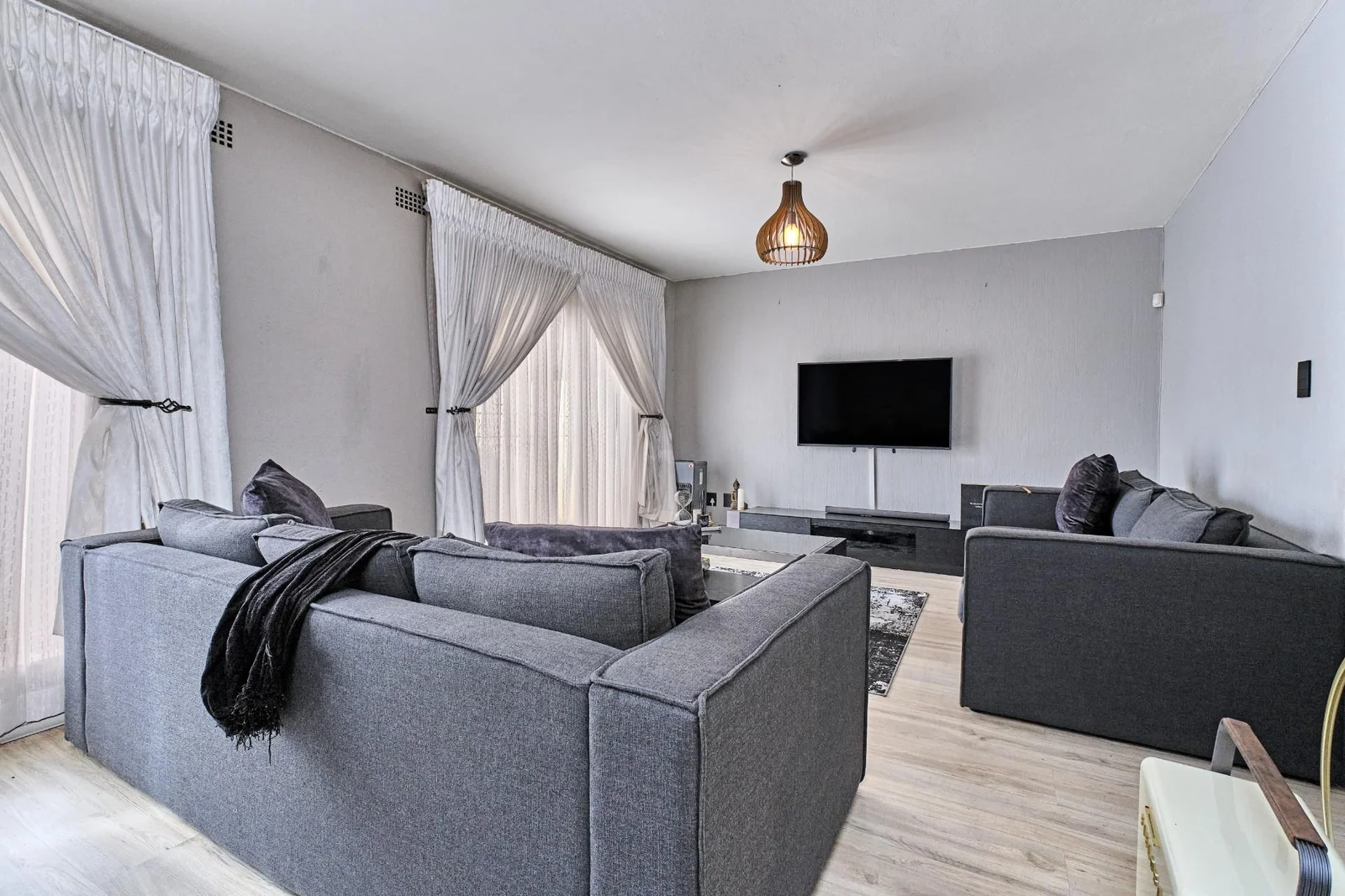 Double-story Townhouse with living spaces below, bedrooms upstairs, and a private garden.