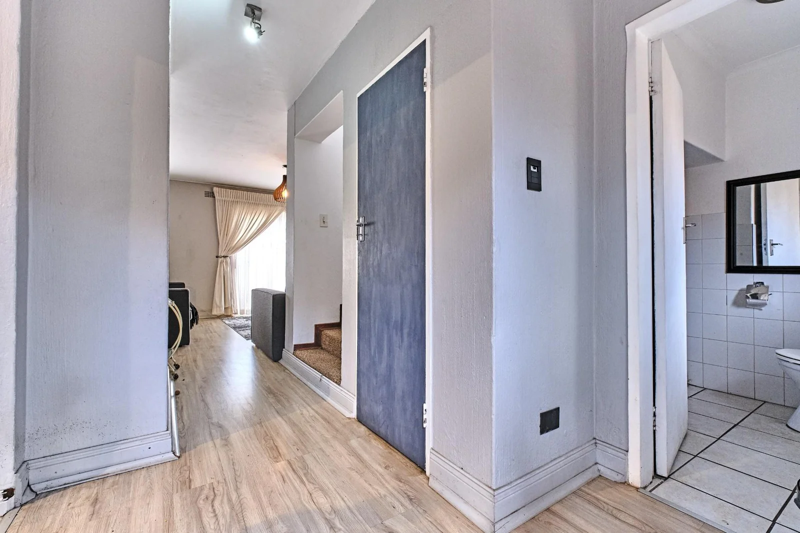 Double-story Townhouse with living spaces below, bedrooms upstairs, and a private garden.