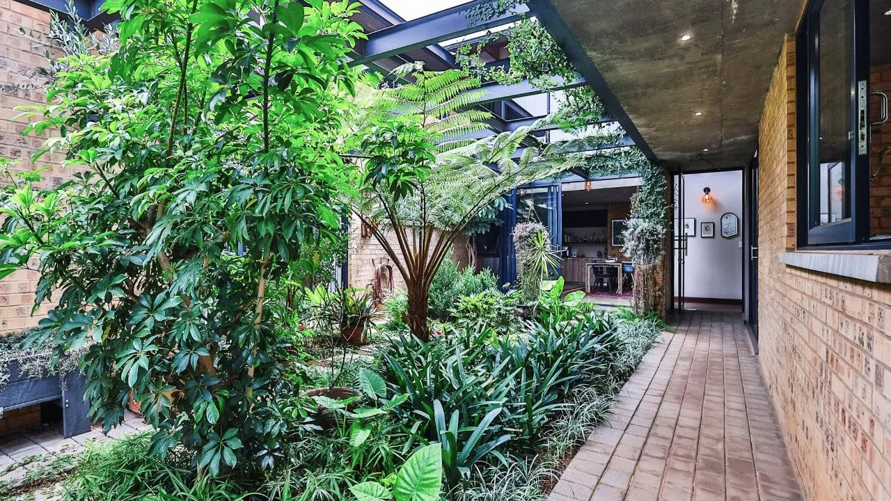 A STRIKING INDUSTRIAL-MODERN HOME WITH A PRIME MIDSTREAM RIDGE LOCATION, MOMENTS FROM AN  ACCESS GATE