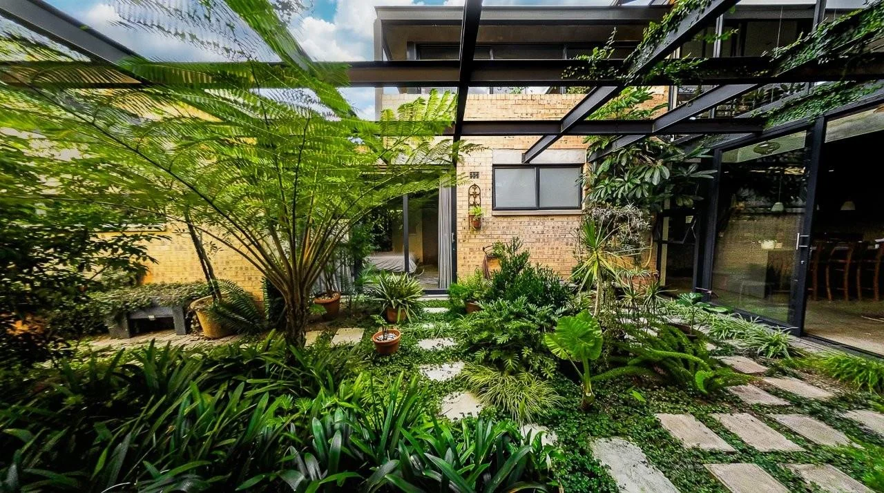 A STRIKING INDUSTRIAL-MODERN HOME IN  A PRIME MIDSTREAM RIDGE LOCATION, MOMENTS FROM AN  ACCESS GATE