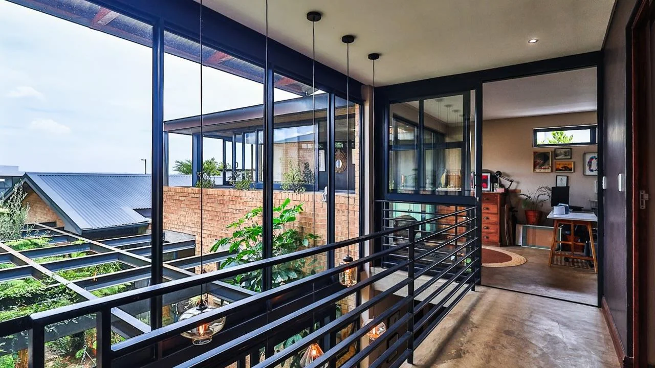 A STRIKING INDUSTRIAL-MODERN HOME WITH A PRIME MIDSTREAM RIDGE LOCATION, MOMENTS FROM AN  ACCESS GATE