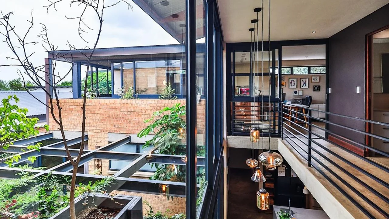 A STRIKING INDUSTRIAL-MODERN HOME WITH A PRIME MIDSTREAM RIDGE LOCATION, MOMENTS FROM AN  ACCESS GATE