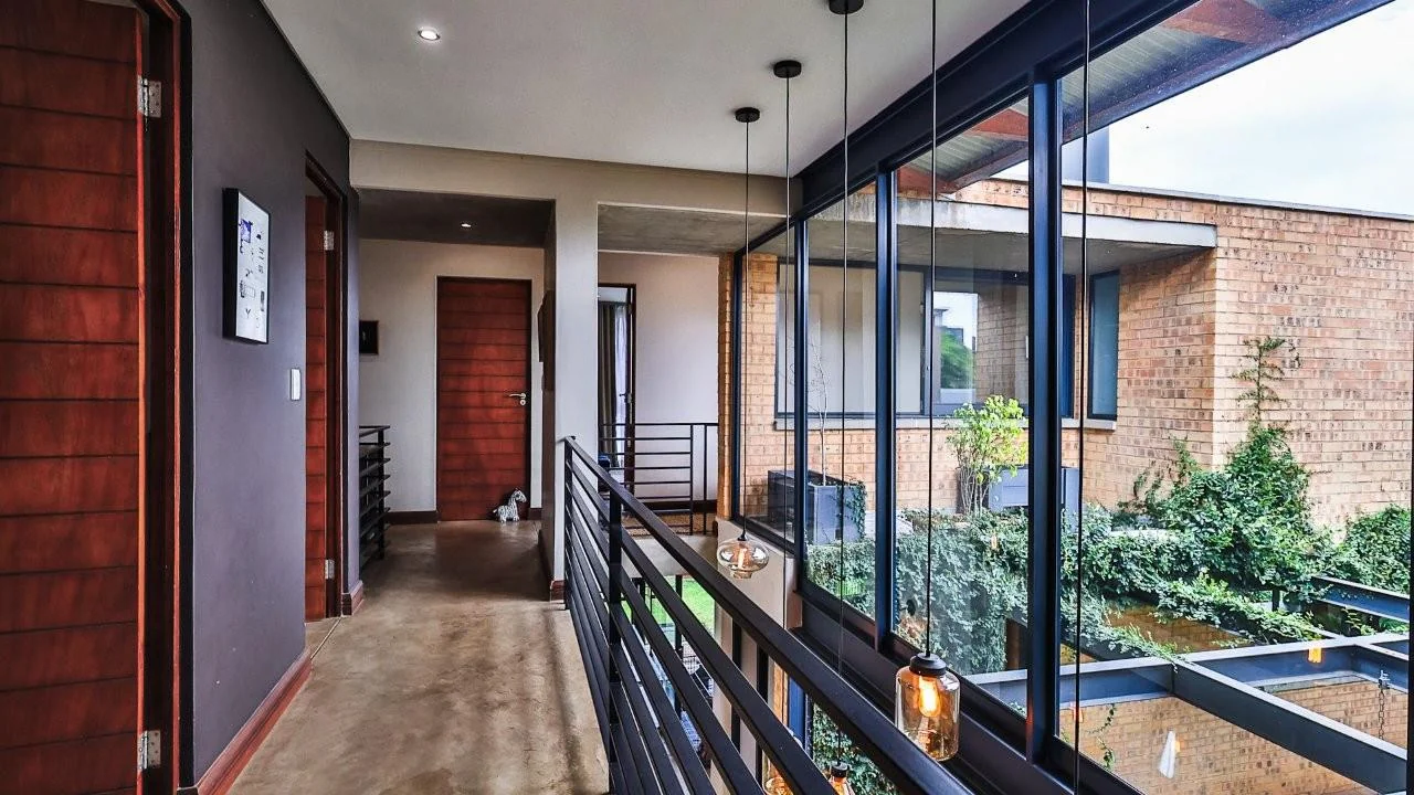 A STRIKING INDUSTRIAL-MODERN HOME WITH A PRIME MIDSTREAM RIDGE LOCATION, MOMENTS FROM AN  ACCESS GATE