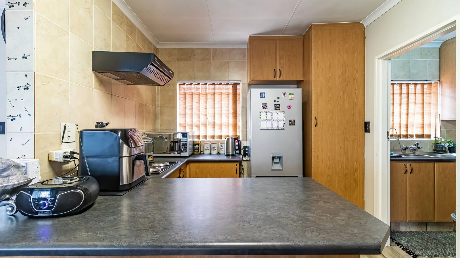 3-BEDROOM HOME WITH PRIVATE 2-BEDROOM FLATLET, INCOME POTENTIAL & ENTERTAINMENT SPACES IN A SECURE BOOMED-OFF AREA